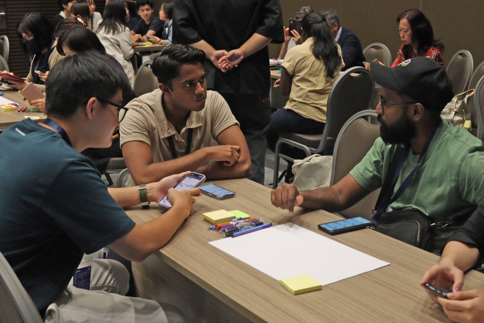 Participants at a table discussing problems elderly Singaporeans face